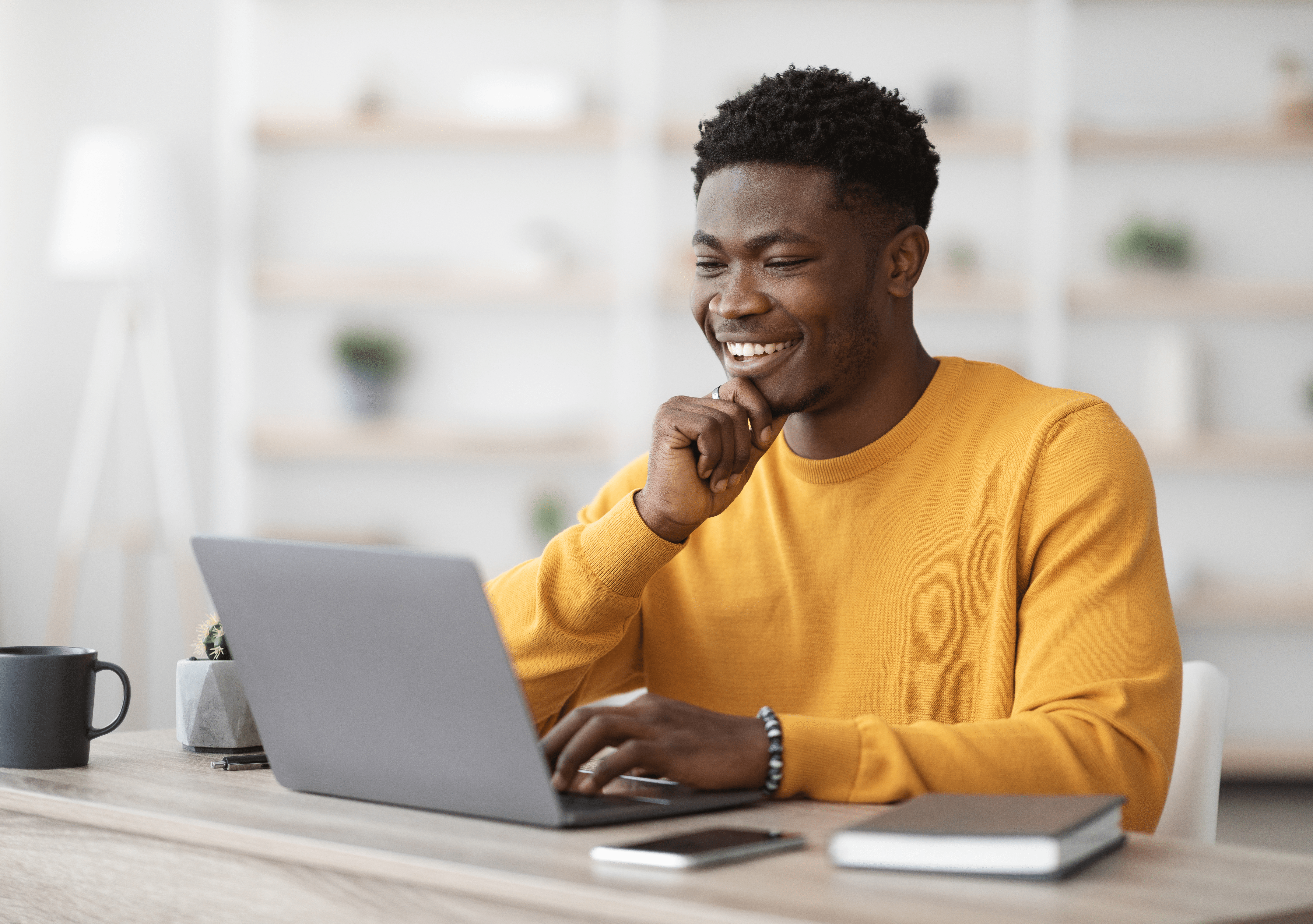 Smiling man working at laptop