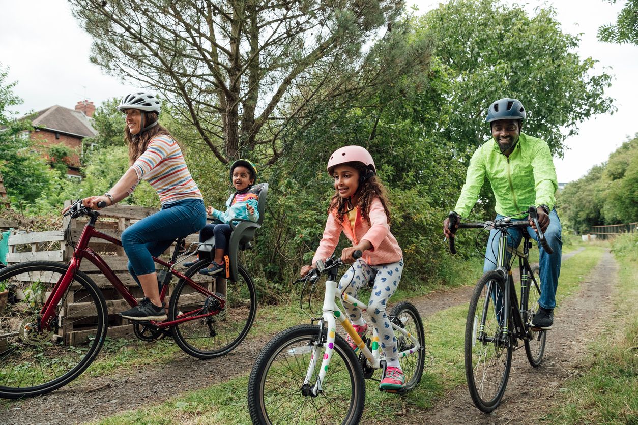 Family out on a bike ride in the woods.